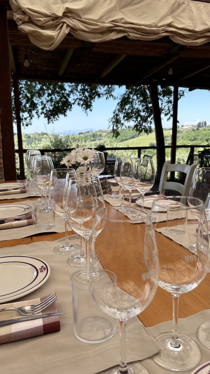 Winery-lunch-table-set-with-wine-glasses-overlooking-the-Tuscan-hills.jpg